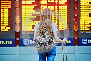 Tourist girl with backpack in international airport