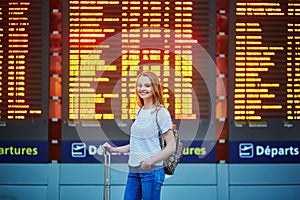 Tourist girl with backpack in international airport