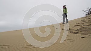 Tourist girl among Curonian Spit sand dunes