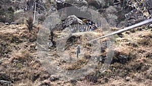 A tourist girl doing rope rappelling in