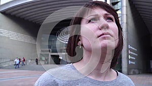 Tourist girl and looks the European Parliament in Brussels. Belgium. slow motion. dolly zoom effect