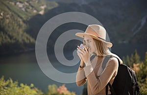 A tourist girl is resting after a hard climb up the mountain