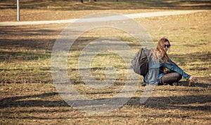 Tourist girl with rucksack taking a break