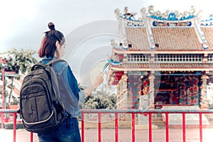 Tourist girl`s hold a map and looking at view Travel location Cu