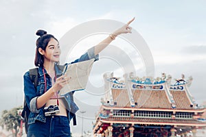 Tourist girl`s hold a map and looking at view Travel location Cultural and smiling on the day trip