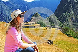 A tourist girl sitting in Machu Picchu, Peru