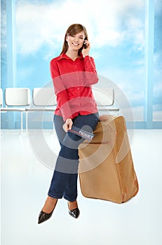 Tourist girl sitting on a suitcase