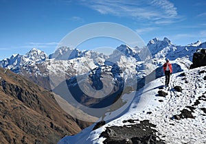 Tourist girl in the snow-capped mountains of the Elbrus region