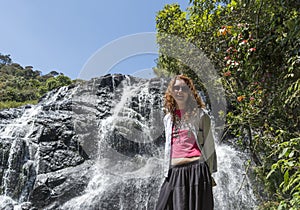 Tourist girl standing near the Baker`s falls in the national park