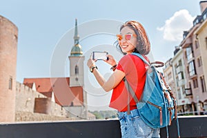Tourist girl taking pictures on her smartphone