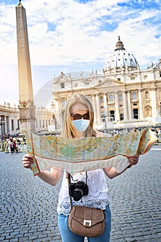 Tourist girl visits vatican with map