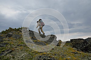 Tourist girl walking along the ridge