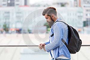 Tourist handsome thoughtful hipster backpack. Man with beard and rucksack explore city. Travelling concept. Tourist on