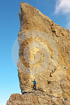 Tourist on the heel of a high rock of rocky port La Breche de Roland, border between France and Spain, Pyrenees