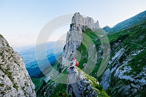 Tourist on the high rocks background. Sport and active life concept. Adventure and travel in Switzerland
