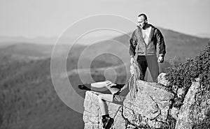 Tourist hiker girl and man relaxing. Hiking benefits. Hiking weekend. On edge of world. Woman sit edge of cliff high