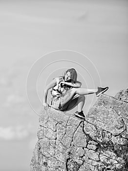 Tourist hiker girl relaxing edge cliff. Dangerous relax. Extreme concept. On edge of world. Woman sit on edge of cliff