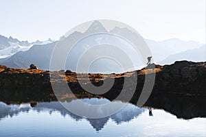 Tourist hiking near Lac de Cheserys lake in French Alps