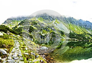 Tourist hiking trail along the picturesque mountain lake