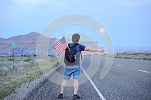 Tourist hitchhiking along a desolate road