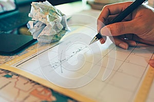 Tourist hold pen and planning vacation with calendar and map. Cross line in holiday text and crump paper map . Cancel