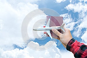 Tourist holding airplane and passport flight travel traveler fly on the blue sky for travelling citizenship air on the around worl