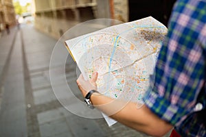 Tourist holding map and sightseeing in city