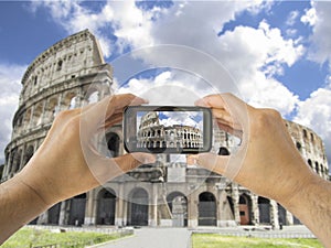 Tourist holds up camera mobile at coliseum in Rome