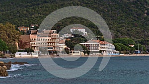 Tourist hotels on the shore near Le Lavandou at the French Riviera on sunny day in autumn viewed from beach Plage du Layet. photo