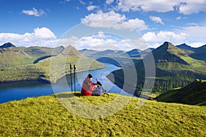 Tourist at Hvithamar Hill Top With Funningsfjordur Fjord View, Faroe Islands