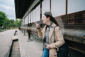 Tourist joyfully pointing to the beautiful garden