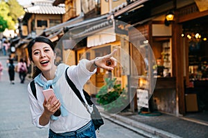 Tourist joyfully pointing to the shop