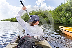 Tourist kayaking in mangrove forest in Everglades Florida, USA