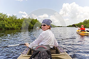 Tourist kayaking in mangrove forest in Everglades Florida, USA
