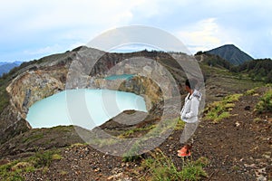 Tourist on Kelimutu watching unique lakes Tap and Tin photo