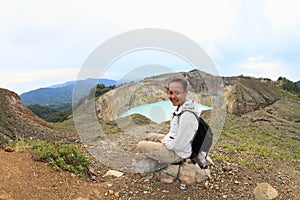 Tourist on Kelimutu watching unique lakes Tap and Tin photo