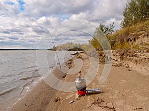 Tourist kettle on a gas stove on the banks of the Irtysh River