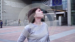 Tourist lady walks and looks at attractions near the European Parliament in Brussels. Belgium. slow motion.dolly zoom