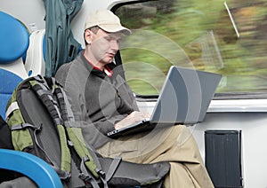 Tourist with laptop in the train