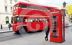 Tourist in London - telephone booth and double decker photo