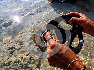 A tourist looking for Anemone fish swim around coral at Surin islands national park, Phang Nga. Thailand