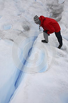 Tourist looking into a crevasse - Argentina photo