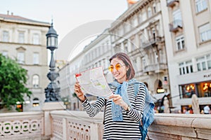 Tourist looking at the map on the street of european city, travel to Europe concept