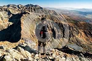 Tourist looking on mountains from top of the peak. View from hill Krivan in High Tatras mountains, Slovakia