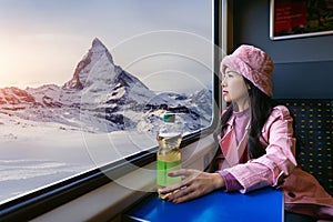 Tourist looking out the window enjoying with Train passing through famous mountain