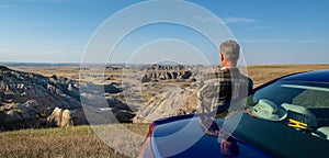 A tourist looks at the scenery off Badlands Loop Road