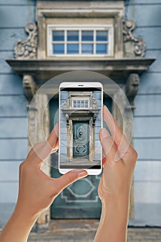 Tourist makes a photo of old blue door in Riga