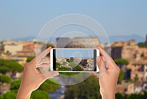 Tourist makes a photo of Rome skyline colosseum