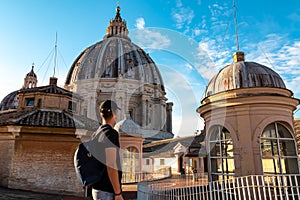 Rome - Tourist man with close up view on the main dome of Saint Peter basilica in Vatican city, Rome, Europe