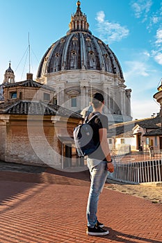 Rome - Tourist man with close up view on the main dome of Saint Peter basilica in Vatican city, Rome, Europe